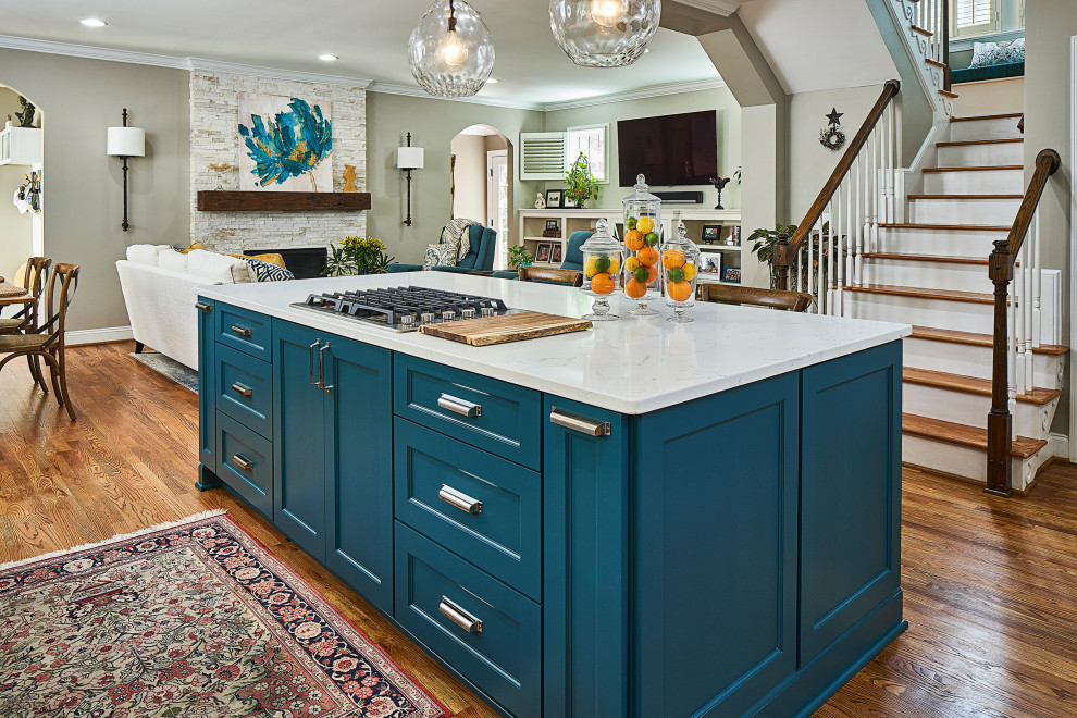 Inspiration for a mid-sized transitional u-shaped medium tone wood floor, brown floor and exposed beam open concept kitchen remodel in Charlotte with an undermount sink, recessed-panel cabinets, turquoise cabinets, quartz countertops, blue backsplash, glass tile backsplash, stainless steel appliances, an island and white countertops