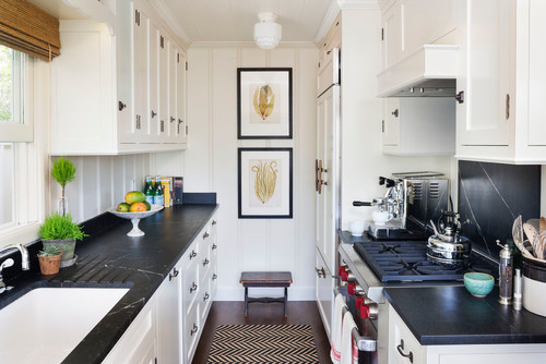 Narrow galley kitchen with white shaker premium RTA cabinets Canada, black stone countertops, gas range, and compact storage.