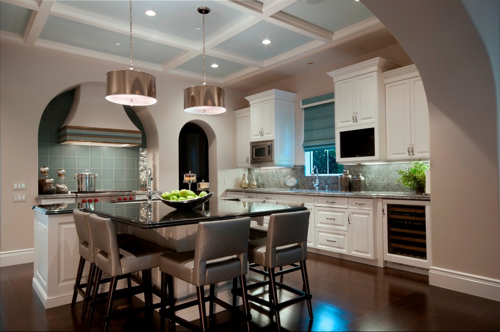 Trendy l-shaped eat-in kitchen photo in Miami with raised-panel cabinets, white cabinets and green backsplash