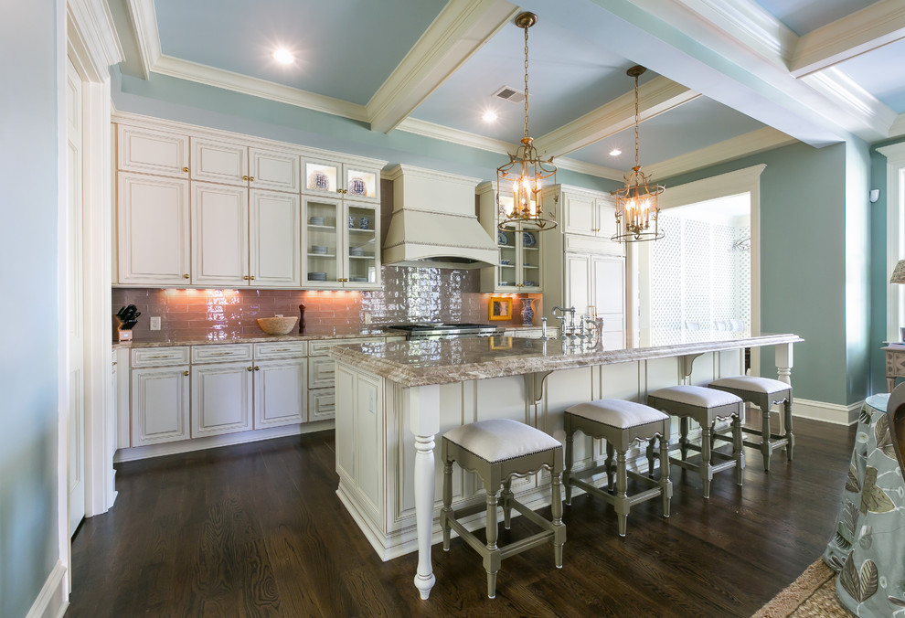 Inspiration for a large transitional single-wall dark wood floor and brown floor open concept kitchen remodel in Charleston with an undermount sink, raised-panel cabinets, white cabinets, granite countertops, beige backsplash, glass tile backsplash, stainless steel appliances and an island