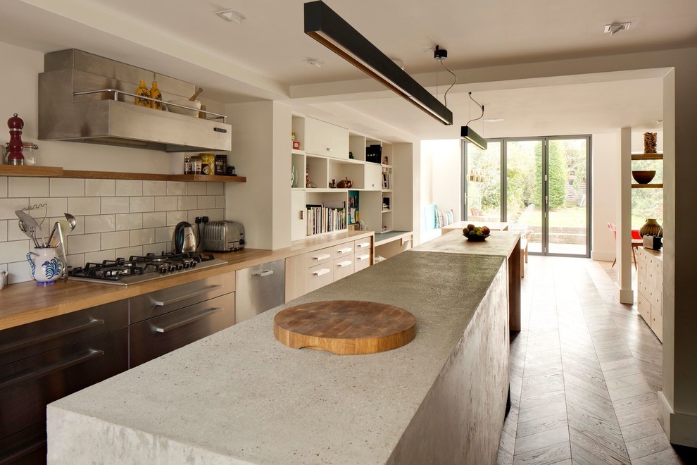 Exempel på ett mellanstort kök, med en undermonterad diskho, släta luckor, skåp i ljust trä, bänkskiva i betong, grått stänkskydd, stänkskydd i sten, rostfria vitvaror och mellanmörkt trägolv