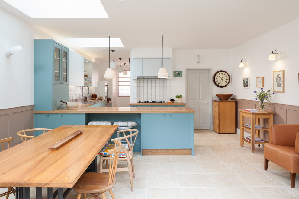 Photo of a contemporary kitchen in London with blue cabinets.