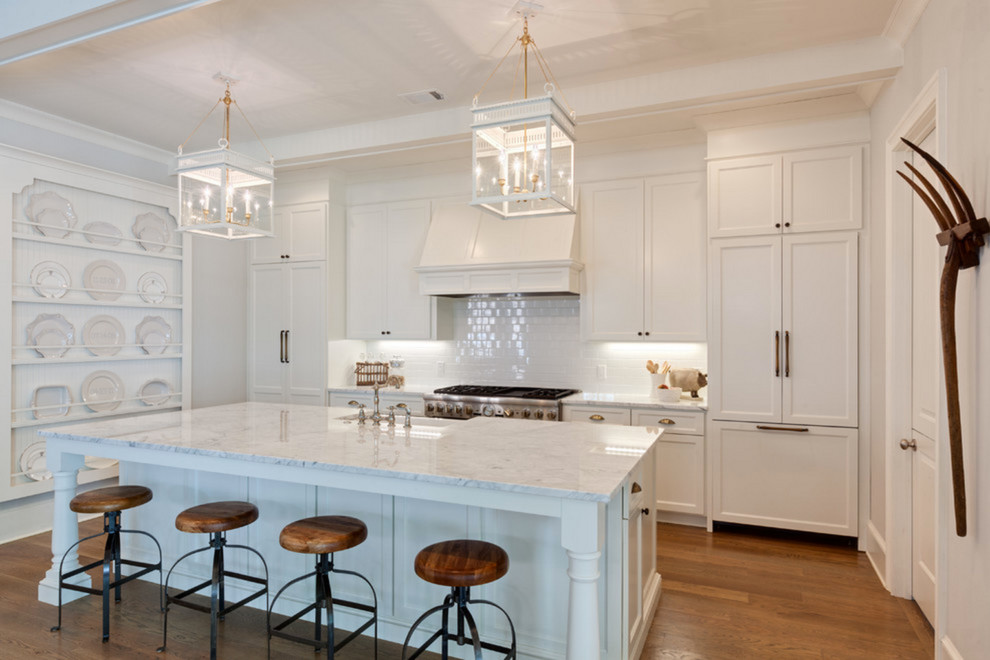 Inspiration for a large country single-wall medium tone wood floor eat-in kitchen remodel in Los Angeles with shaker cabinets, white cabinets, marble countertops, an island, a farmhouse sink, white backsplash, subway tile backsplash and stainless steel appliances