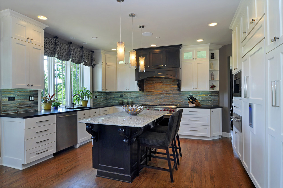 Eat-in kitchen - large transitional u-shaped medium tone wood floor eat-in kitchen idea in Chicago with an undermount sink, white cabinets, granite countertops, multicolored backsplash, stone tile backsplash, stainless steel appliances, an island and flat-panel cabinets