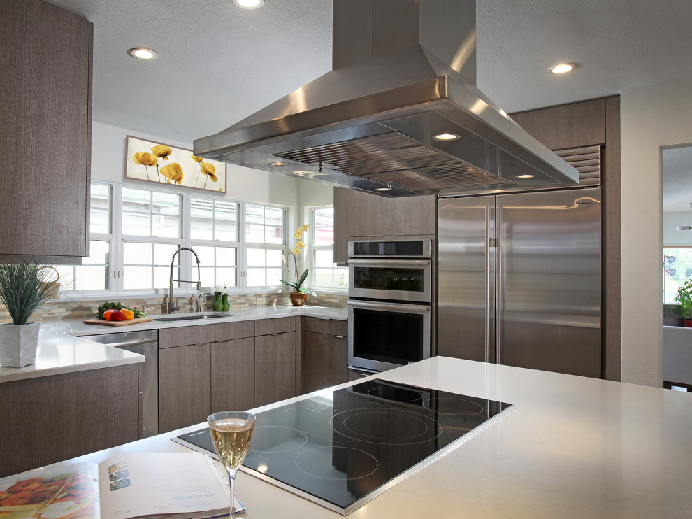 Design ideas for a small contemporary u-shaped kitchen/diner in Tampa with grey cabinets, stainless steel appliances, an island, a submerged sink, flat-panel cabinets, quartz worktops, light hardwood flooring and beige floors.
