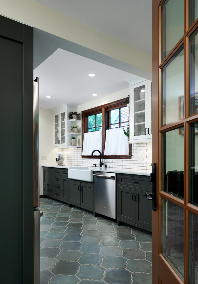 Mid-sized tuscan galley cement tile floor and green floor eat-in kitchen photo in Minneapolis with a farmhouse sink, shaker cabinets, quartz countertops, multicolored backsplash, ceramic backsplash and stainless steel appliances