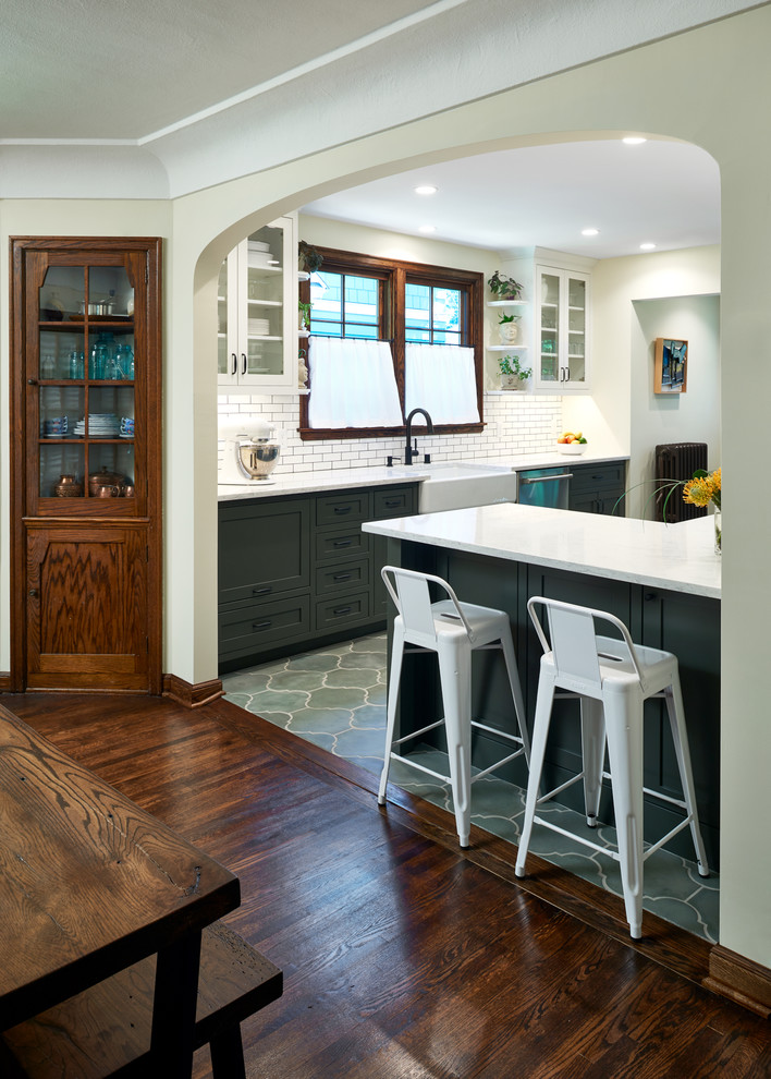 Inspiration for a mid-sized mediterranean galley cement tile floor and green floor eat-in kitchen remodel in Minneapolis with a farmhouse sink, shaker cabinets, quartz countertops, multicolored backsplash, ceramic backsplash and stainless steel appliances