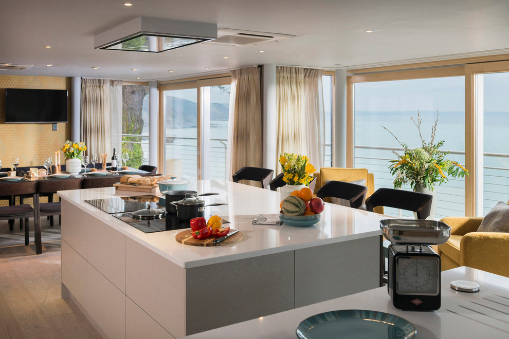 Inspiration for a coastal eat-in kitchen remodel in Cornwall with two islands