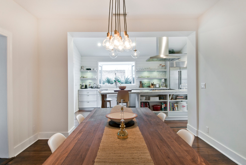 Eat-in kitchen - mid-sized farmhouse galley painted wood floor eat-in kitchen idea in Los Angeles with a farmhouse sink, shaker cabinets, white cabinets, marble countertops, white backsplash, wood backsplash, stainless steel appliances and an island