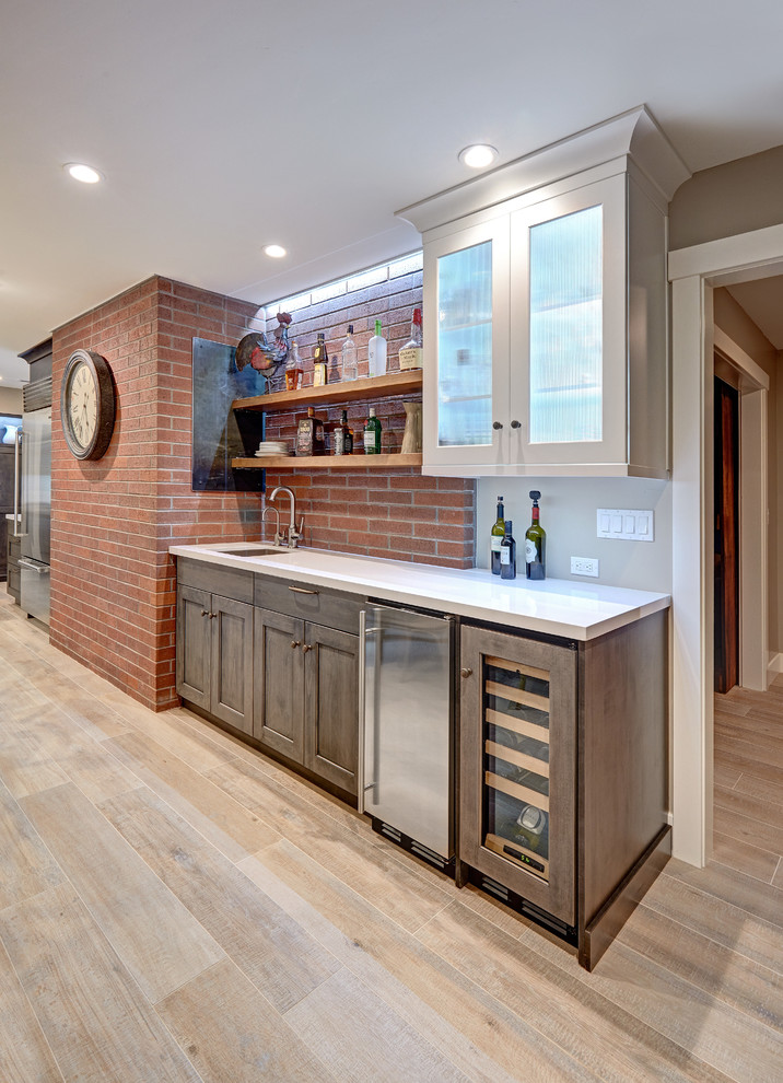 Example of a large eclectic u-shaped porcelain tile home bar design in Sacramento with an undermount sink, recessed-panel cabinets, gray cabinets and quartz countertops