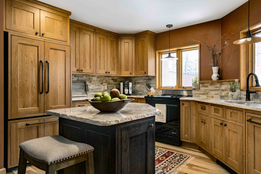 Example of a large mountain style u-shaped kitchen design in Burlington with recessed-panel cabinets, medium tone wood cabinets, an island, an undermount sink, multicolored backsplash, paneled appliances and multicolored countertops