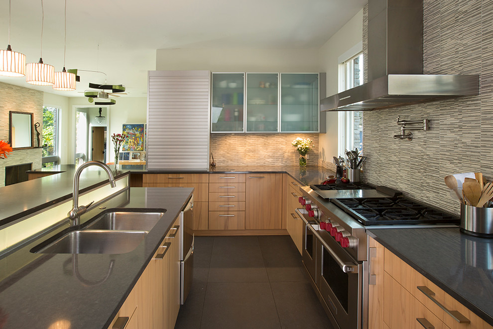Example of a trendy u-shaped porcelain tile kitchen design in Chicago with a double-bowl sink, flat-panel cabinets, light wood cabinets, quartz countertops, multicolored backsplash, mosaic tile backsplash and stainless steel appliances