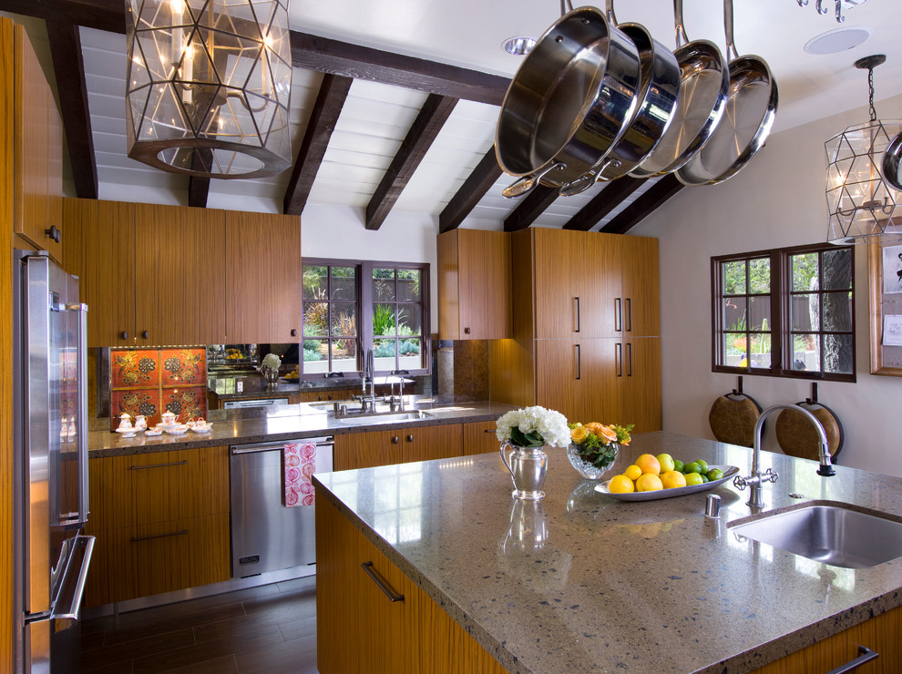 Example of a mid-sized tuscan u-shaped dark wood floor enclosed kitchen design in Los Angeles with a double-bowl sink, flat-panel cabinets, light wood cabinets, granite countertops, metallic backsplash, mirror backsplash and stainless steel appliances
