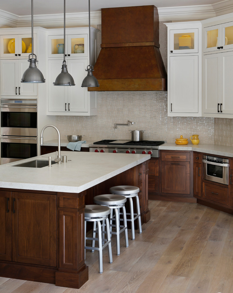 Photo of a classic l-shaped kitchen/diner in San Francisco with a submerged sink, shaker cabinets, dark wood cabinets and stainless steel appliances.