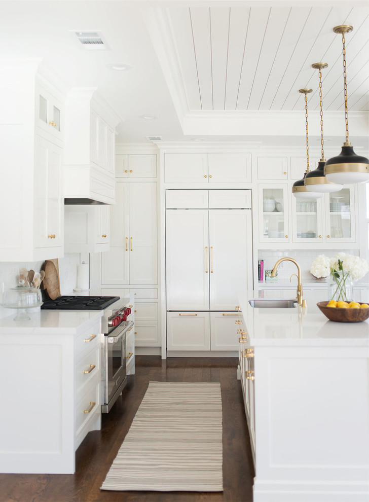Large transitional l-shaped dark wood floor eat-in kitchen photo in Salt Lake City with a drop-in sink, white cabinets, quartzite countertops, white backsplash, subway tile backsplash and an island