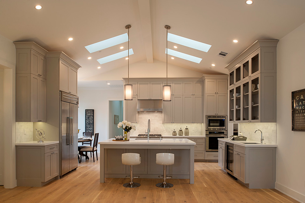 Inspiration for a craftsman kitchen remodel in San Francisco with shaker cabinets, gray cabinets, marble countertops, white backsplash and an island