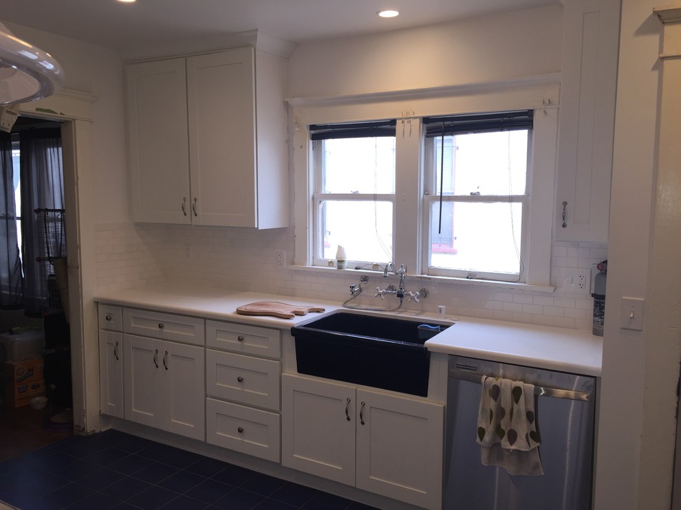 Inspiration for a small traditional galley kitchen/diner in Los Angeles with a belfast sink, shaker cabinets, white cabinets, quartz worktops, white splashback, metro tiled splashback, stainless steel appliances, ceramic flooring, no island, white worktops and blue floors.