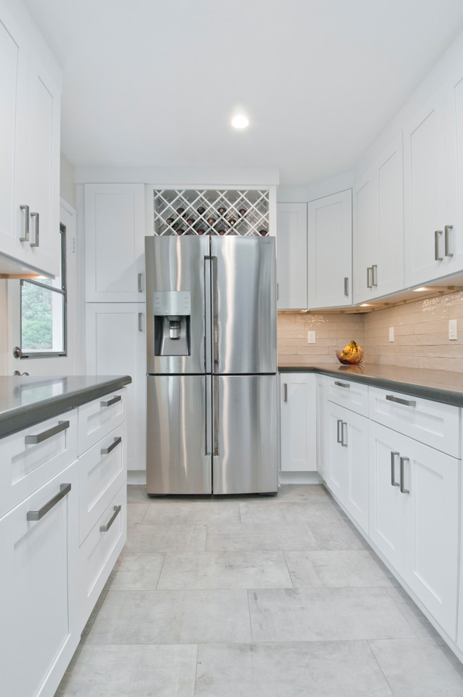 Enclosed kitchen - small transitional galley porcelain tile and gray floor enclosed kitchen idea in Los Angeles with an undermount sink, shaker cabinets, white cabinets, quartzite countertops, white backsplash, terra-cotta backsplash, stainless steel appliances, a peninsula and gray countertops