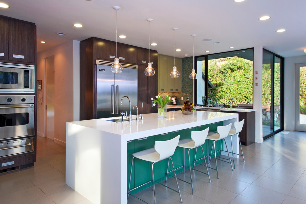 Example of a large trendy single-wall ceramic tile eat-in kitchen design in Los Angeles with an island, a single-bowl sink, flat-panel cabinets, dark wood cabinets, granite countertops, multicolored backsplash, mosaic tile backsplash and stainless steel appliances