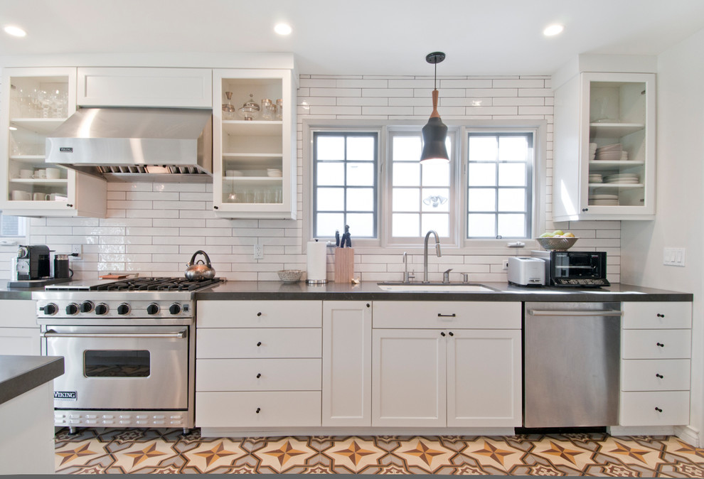 Inspiration for a mid-sized transitional galley cement tile floor and multicolored floor open concept kitchen remodel in Los Angeles with an undermount sink, shaker cabinets, white cabinets, quartzite countertops, white backsplash, ceramic backsplash, stainless steel appliances and an island