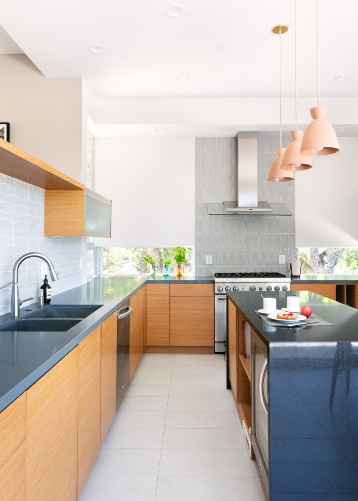 Design ideas for a contemporary l-shaped kitchen in San Francisco with a submerged sink, flat-panel cabinets, medium wood cabinets, grey splashback, stainless steel appliances, an island, grey floors and blue worktops.