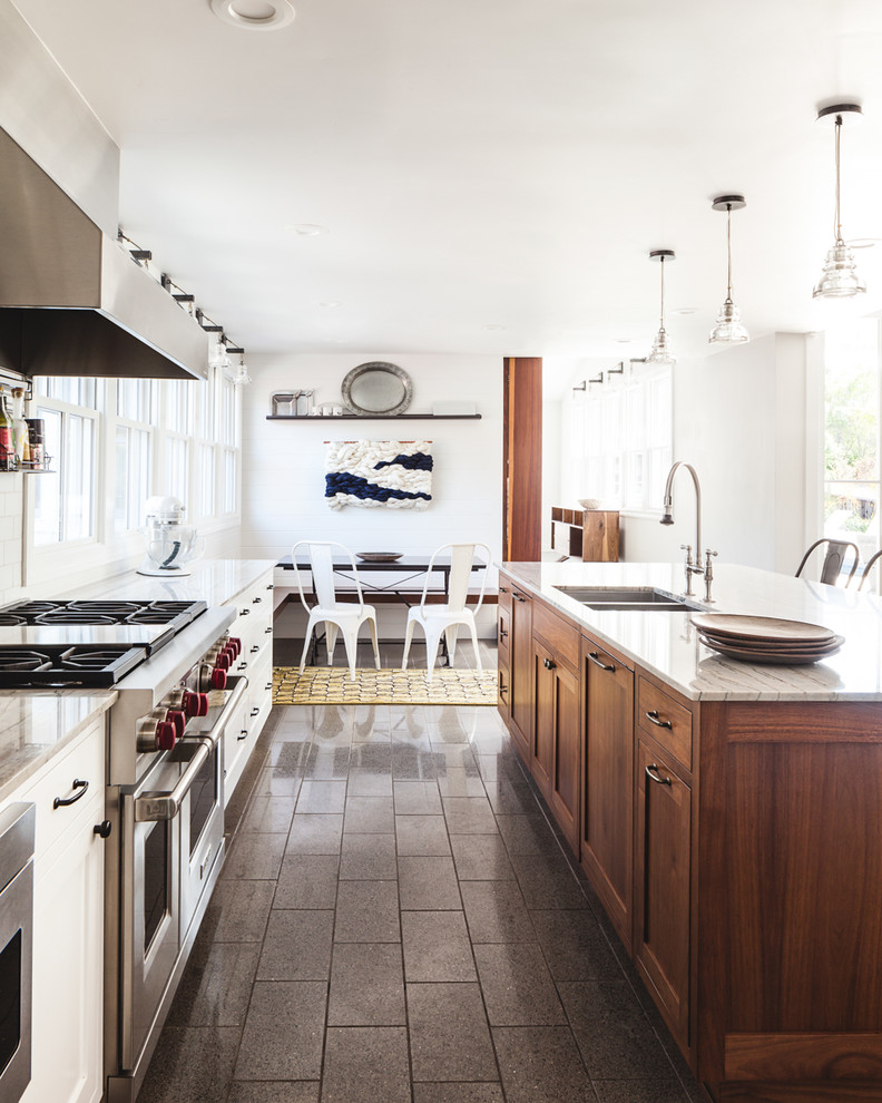 Inspiration for a large cottage galley porcelain tile open concept kitchen remodel in San Francisco with an undermount sink, shaker cabinets, medium tone wood cabinets, quartzite countertops, white backsplash, ceramic backsplash, stainless steel appliances and an island