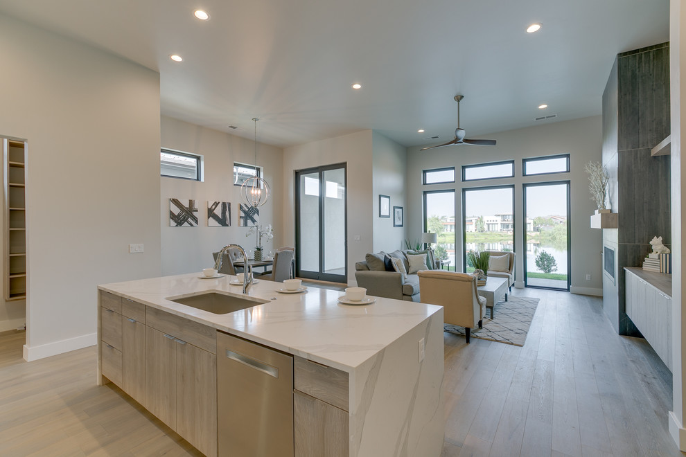 Inspiration for a mid-sized modern u-shaped light wood floor and beige floor eat-in kitchen remodel in Boise with an undermount sink, flat-panel cabinets, white cabinets, quartz countertops, gray backsplash, ceramic backsplash, stainless steel appliances, an island and white countertops