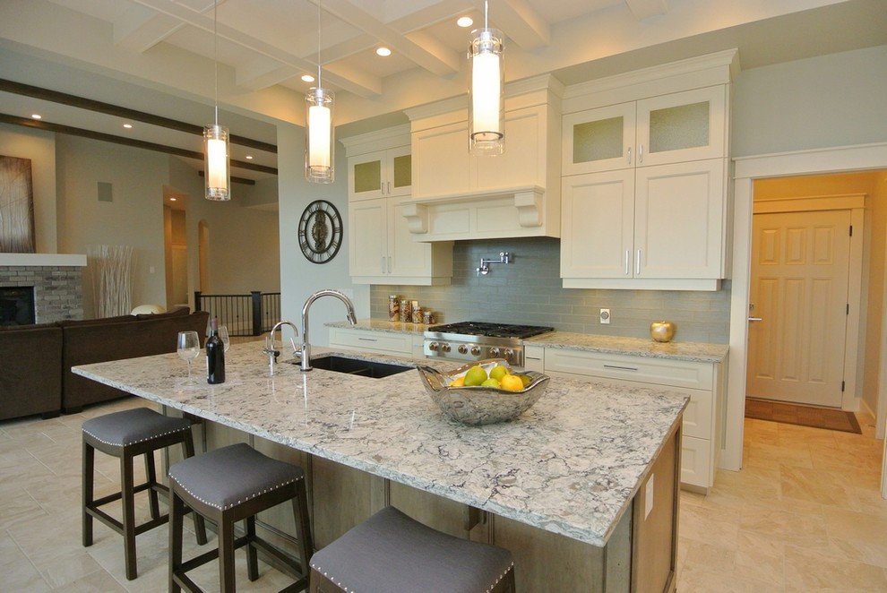 Large transitional l-shaped ceramic tile and beige floor eat-in kitchen photo in Other with an undermount sink, shaker cabinets, white cabinets, gray backsplash, glass tile backsplash, stainless steel appliances, quartzite countertops, an island and gray countertops