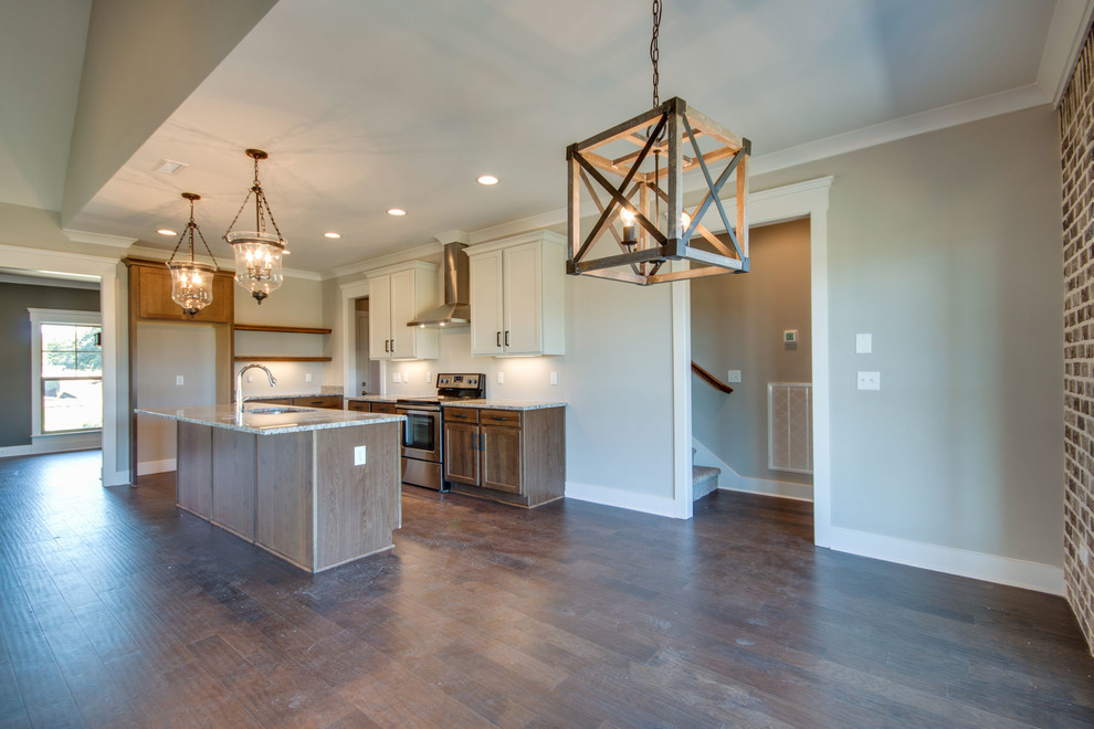 Inspiration for a mid-sized craftsman l-shaped medium tone wood floor and brown floor eat-in kitchen remodel in Nashville with an undermount sink, shaker cabinets, medium tone wood cabinets, granite countertops, an island and multicolored countertops