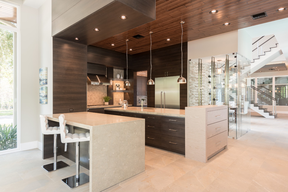 Photo of a contemporary u-shaped open plan kitchen in Orlando with a submerged sink, flat-panel cabinets, dark wood cabinets, beige splashback, mosaic tiled splashback, stainless steel appliances, an island, beige floors and beige worktops.