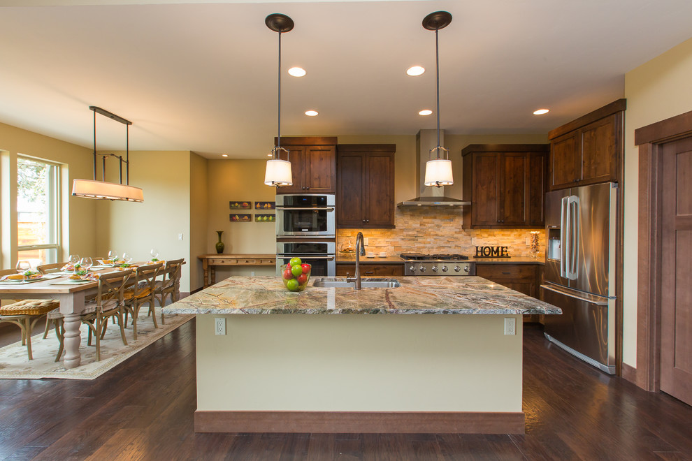 Inspiration for a large timeless l-shaped dark wood floor eat-in kitchen remodel in Portland with a single-bowl sink, shaker cabinets, dark wood cabinets, quartzite countertops, beige backsplash, stainless steel appliances and an island