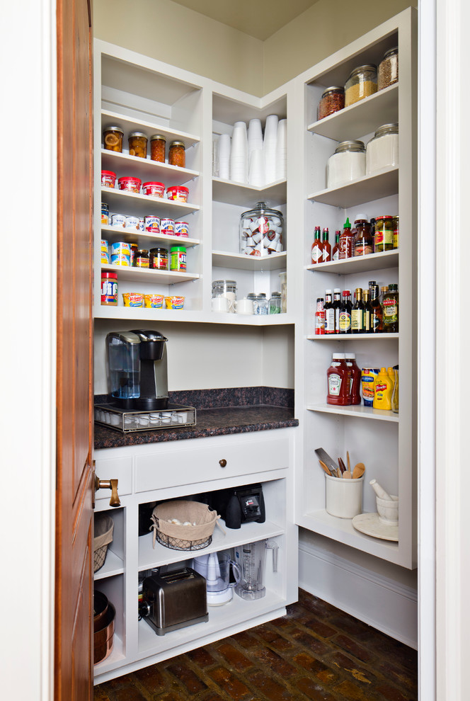 Elegant brick floor kitchen pantry photo in New Orleans with open cabinets, white cabinets and laminate countertops