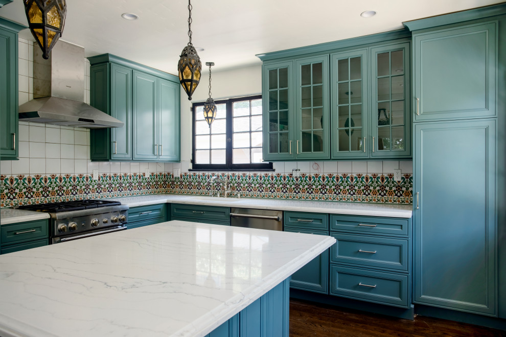 Inspiration for a large mediterranean l-shaped dark wood floor and brown floor open concept kitchen remodel in Los Angeles with shaker cabinets, turquoise cabinets, quartz countertops, multicolored backsplash, porcelain backsplash, stainless steel appliances, an island and white countertops