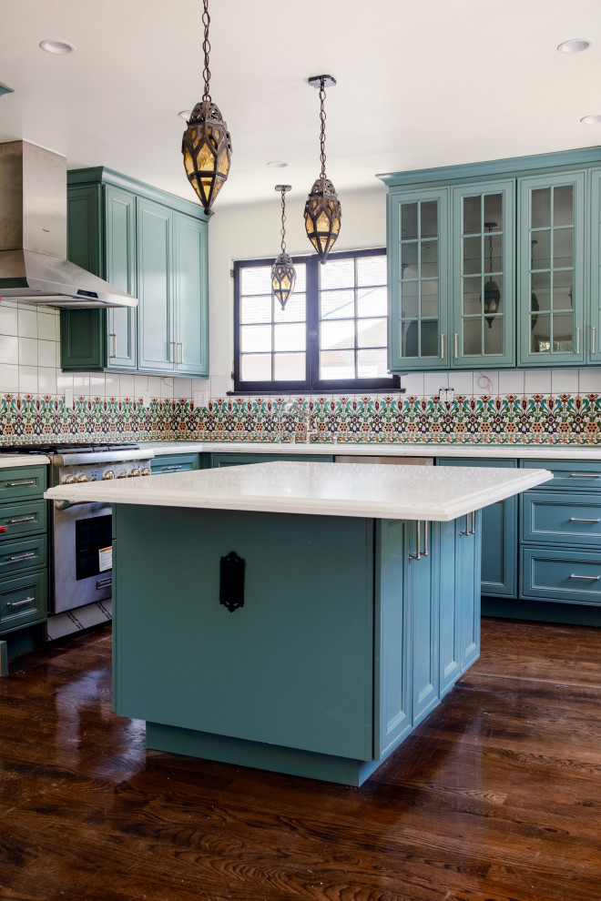 Inspiration for a large mediterranean l-shaped dark wood floor and brown floor open concept kitchen remodel in Los Angeles with shaker cabinets, turquoise cabinets, quartz countertops, multicolored backsplash, porcelain backsplash, stainless steel appliances, an island and white countertops