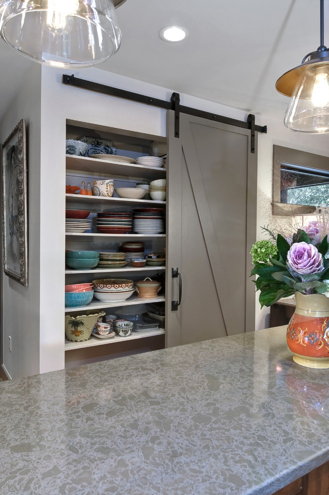 Example of a mid-sized transitional kitchen design in Charleston with gray cabinets, recessed-panel cabinets and an island
