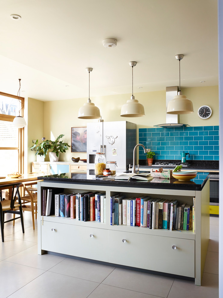This is an example of a large midcentury open plan kitchen in London with a double-bowl sink, flat-panel cabinets, grey cabinets, granite worktops, green splashback, ceramic splashback, stainless steel appliances, porcelain flooring, an island and beige floors.
