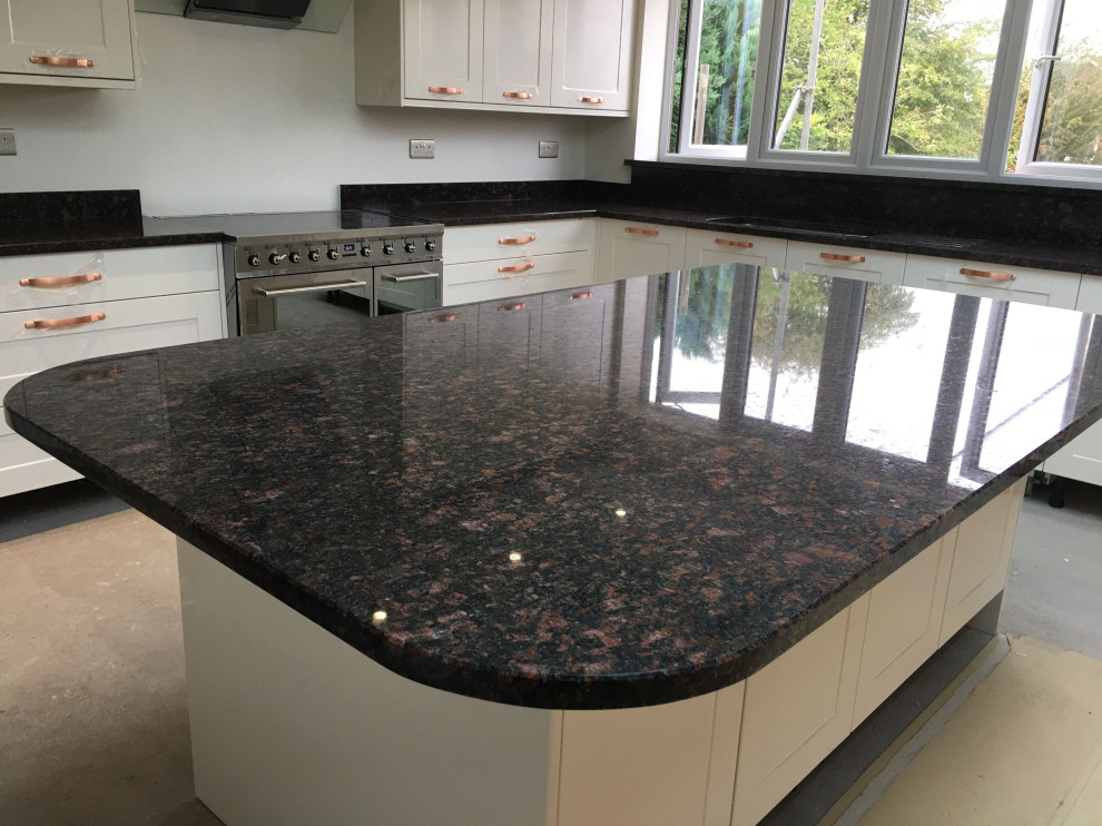 Photo of a country kitchen in London with granite worktops and brown worktops.