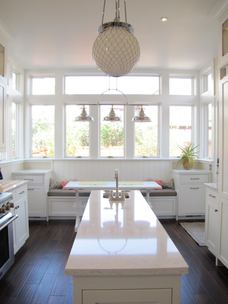 Inspiration for a mid-sized craftsman ceramic tile kitchen remodel in Minneapolis with a farmhouse sink, shaker cabinets, white cabinets, quartzite countertops, gray backsplash, ceramic backsplash, stainless steel appliances and an island