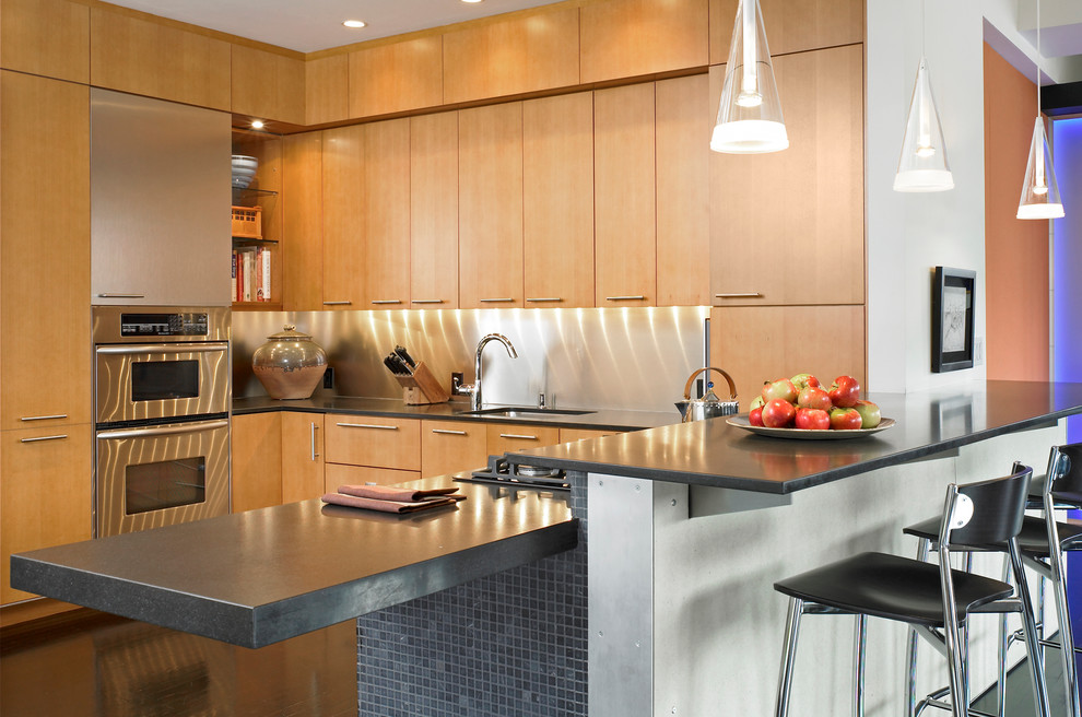 Inspiration for a contemporary kitchen remodel in Boston with an undermount sink, flat-panel cabinets, light wood cabinets, metallic backsplash, stainless steel appliances and metal backsplash