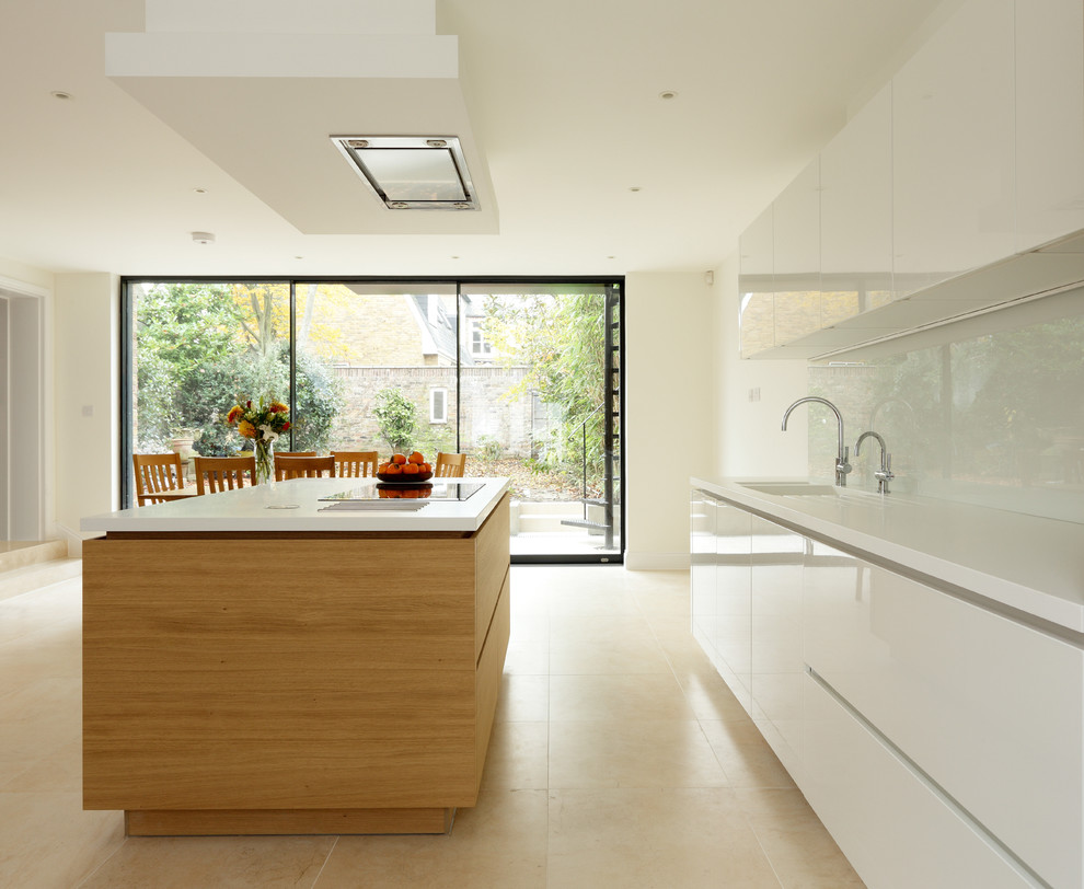 This is an example of a medium sized contemporary single-wall open plan kitchen in London with an integrated sink, flat-panel cabinets, medium wood cabinets, composite countertops, white splashback, glass sheet splashback, stainless steel appliances, porcelain flooring and an island.