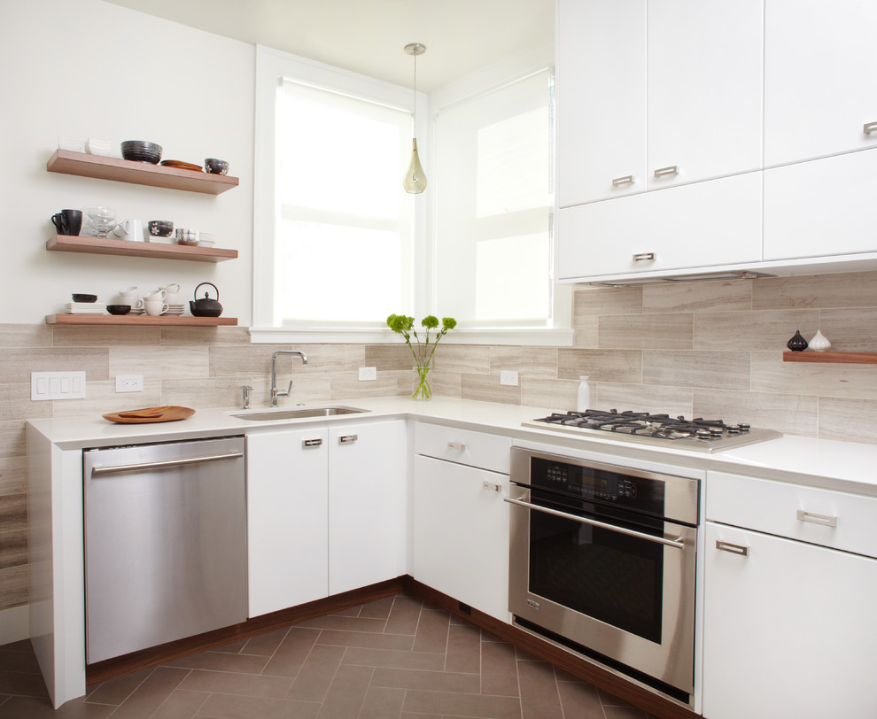 Inspiration for a contemporary enclosed kitchen remodel in San Francisco with quartz countertops, a single-bowl sink, flat-panel cabinets, white cabinets, gray backsplash, stainless steel appliances and limestone backsplash