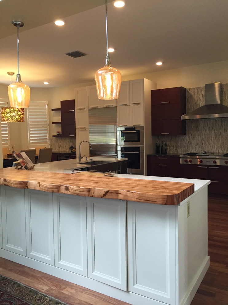 Kitchen - transitional kitchen idea in Miami with wood countertops