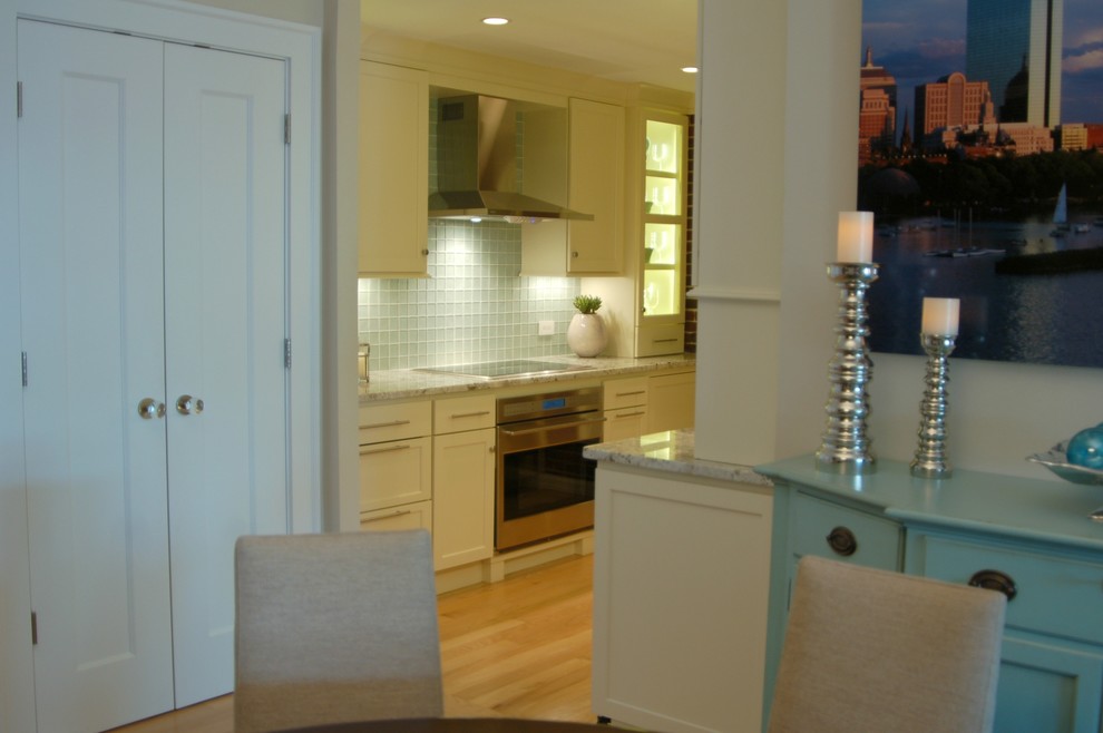 Small beach style galley light wood floor kitchen photo in Boston with an undermount sink, recessed-panel cabinets, white cabinets, granite countertops, stainless steel appliances and no island