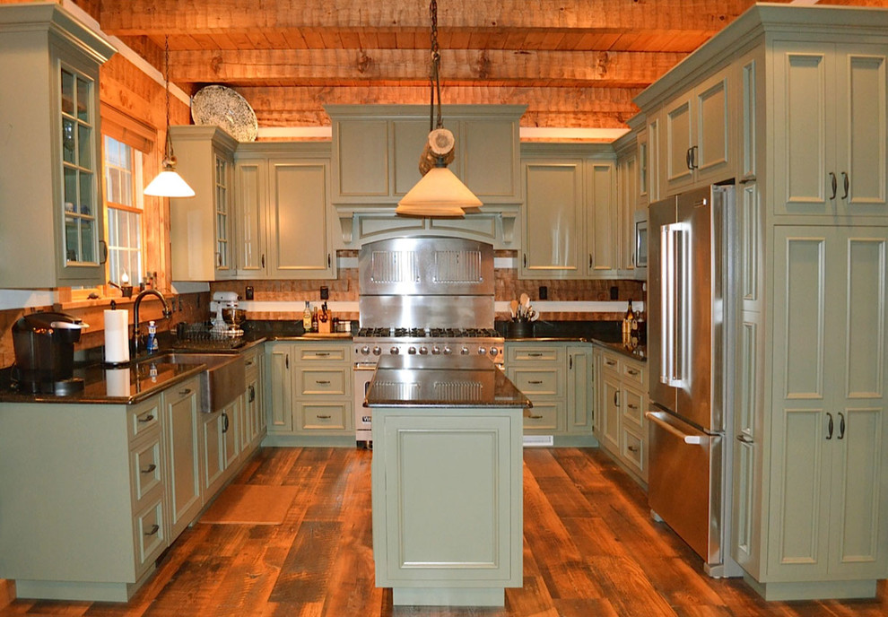 Inspiration for a large country u-shaped separate kitchen in Other with a farmhouse sink, green cabinets, granite benchtops, stainless steel appliances, medium hardwood floors, with island, recessed-panel cabinets, brown splashback and timber splashback.