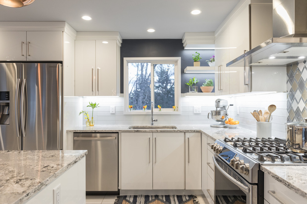 Inspiration for a mid-sized scandinavian l-shaped plywood floor eat-in kitchen remodel in Manchester with an undermount sink, flat-panel cabinets, white cabinets, quartz countertops, multicolored backsplash, glass sheet backsplash, stainless steel appliances and an island
