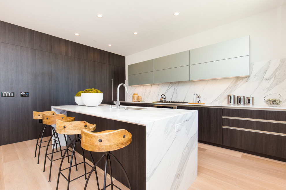 Medium sized contemporary kitchen in San Francisco with a submerged sink, marble worktops, multi-coloured splashback, integrated appliances, light hardwood flooring, an island, flat-panel cabinets, dark wood cabinets, marble splashback and beige floors.