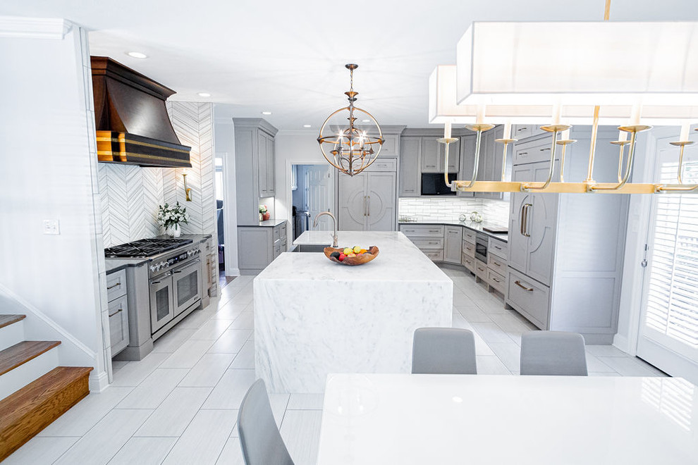 Inspiration for a large modern u-shaped porcelain tile and gray floor kitchen remodel in Other with a farmhouse sink, marble countertops, gray backsplash, marble backsplash, stainless steel appliances, an island and multicolored countertops