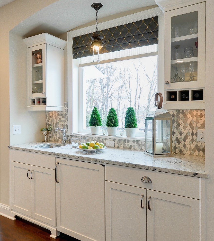 Exempel på ett stort lantligt kök, med en undermonterad diskho, luckor med infälld panel, vita skåp, granitbänkskiva, grått stänkskydd, stänkskydd i porslinskakel, rostfria vitvaror, mörkt trägolv och en köksö
