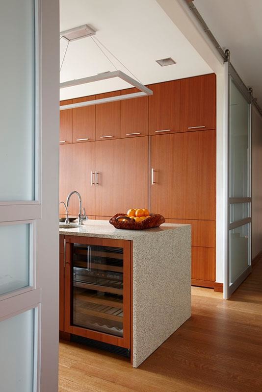 Inspiration for a contemporary medium tone wood floor open concept kitchen remodel in Detroit with dark wood cabinets, stainless steel appliances and two islands