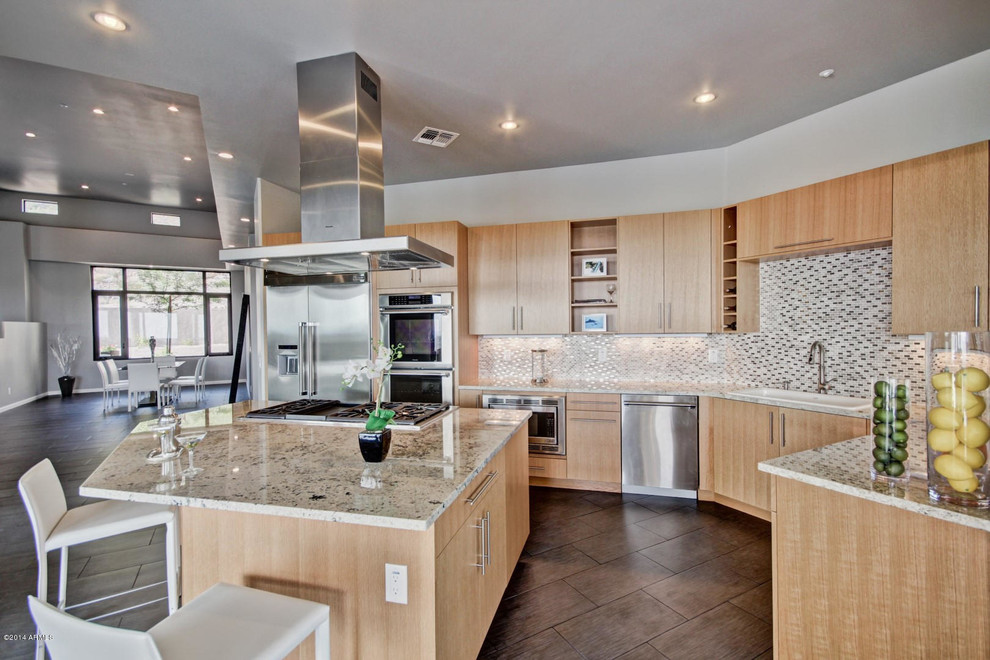 Mid-sized trendy u-shaped porcelain tile open concept kitchen photo in Phoenix with a drop-in sink, flat-panel cabinets, light wood cabinets, granite countertops, multicolored backsplash, mosaic tile backsplash, stainless steel appliances and an island
